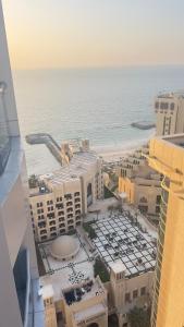una vista aerea sulla spiaggia e sugli edifici di F22R4 Small room attach bath at beach ad Ajman