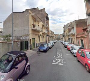 a row of cars parked on the side of a street at Piccola Oasi in Catania