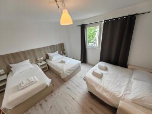 a bedroom with two beds and a window at MILANFORESTER in Milan