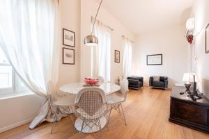 a dining room with a table and chairs at Chic Elegance at Borgo Tommasini Apartment in Parma