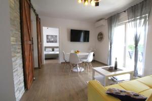 a living room with a couch and a table at Villa MARES in Umag