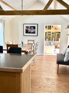 a kitchen and dining room with a table and chairs at Oak Grange holiday cottage in Hoxne