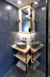two sinks in a bathroom with a glass wall at Czarny Jeleń in Zakopane