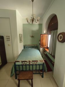 a bedroom with a bed and a table in it at Ξενώνας Μυρτώ in Andritsaina