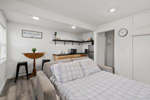 a living room with a bed and a kitchen at Peach Street Super Suite in Medford