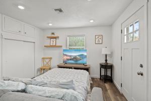 a bedroom with a bed and a desk at Peach Street Super Suite in Medford