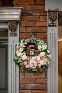 a wreath on the side of a brick wall at Nota Bene Hotel & Restaurant in Lviv