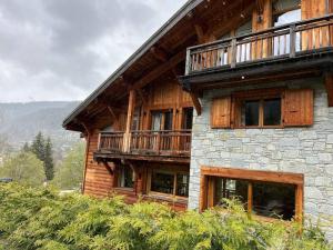 a wooden building with a balcony on the side of it at Chalet Rose in Morzine
