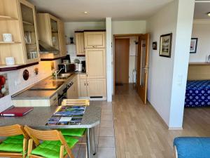 a kitchen with a table and chairs in a room at Apartement Seeblick in Nordstrand