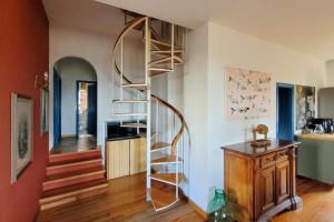a spiral staircase in a room with a kitchen at Homestay in Tuscan countryside with private bathroom and terrace in Borselli
