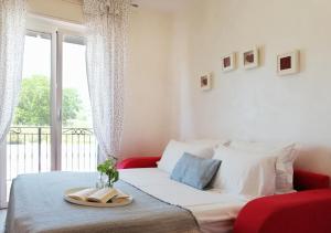 a bedroom with a bed and a large window at Holihome_C&C Sunrise House in Tortoreto Lido