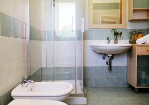 a bathroom with a sink and a shower and a toilet at Holihome_C&C Sunrise House in Tortoreto Lido