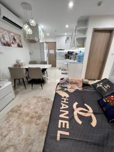 a living room with a kitchen and a dining room at Resort ori , S10 03 luxury Vinhomes Grand pard in Long Bình +9 photos