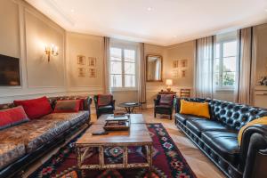 a living room with a couch and a table at La Croce d'Oro Santa Croce Suite Apartments in Florence