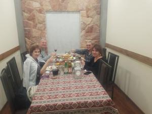 a group of people sitting at a dinner table at Rubin Hotel in Goris