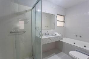 a bathroom with a shower and a sink and a toilet at Exclusivo com 3 dorms na Praça Vilaboim! in São Paulo