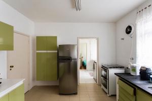 a kitchen with a stainless steel refrigerator in it at Exclusivo com 3 dorms na Praça Vilaboim! in São Paulo