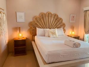 a bedroom with a large bed with two lamps at Follow Your Dreams Gili Air in Gili Islands