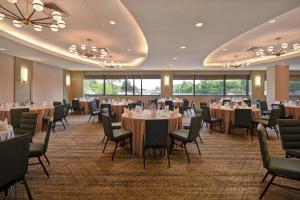 a ballroom with tables and chairs and a ballroom with tables and chairsktop at Four Points by Sheraton Boston Newton in Newton