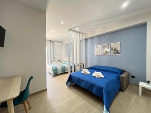 a bedroom with a blue bed and a table at Blue Diamond in Vibo Valentia Marina