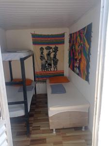 a small room with a bunk bed and a ladder at hostel quintal da sereia in Salvador