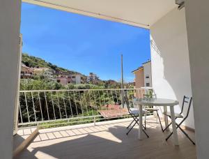 a balcony with a table and chairs and a view at Blue Diamond in Vibo Valentia Marina