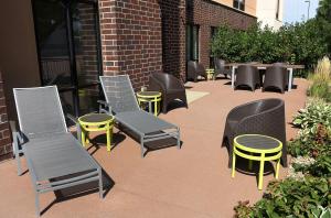 a group of chairs and tables and chairs on a patio at SpringHill Suites by Marriott Sioux Falls in Sioux Falls