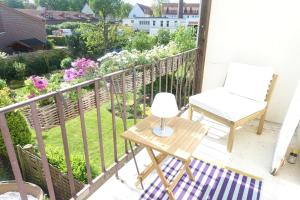 una silla y una mesa en un balcón con flores en Villa mit 4 Schlafzimmer, en Bremen