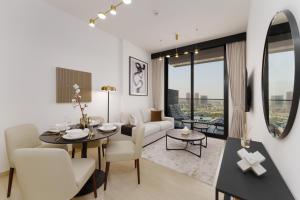 a living room with a table and chairs and a couch at Experience Serenity at Binghatti Crest in JVC in Dubai