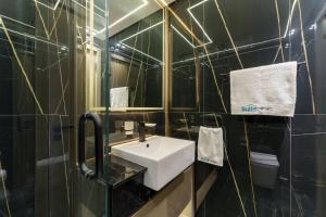 a bathroom with a white sink and a mirror at Experience Serenity at Binghatti Crest in JVC in Dubai