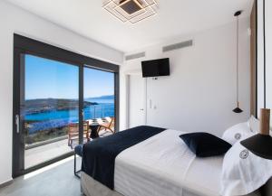 a bedroom with a large bed and a large window at PANTEA LUXURY VILLA in Vasiliki +50 photos