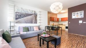 a living room with a couch and a table at UrbanElegance Escape, top location, private parking in Bratislava