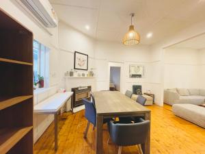 a living room with a table and a couch at D114 Victorian Central Stay in Melbourne