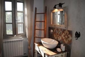 a bathroom with a sink and a mirror at La casa in collina in Cinzano
