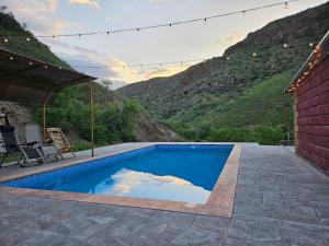 a swimming pool with a view of a mountain at Phoenix Villa in Zarritʼapʼ