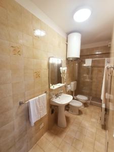 a bathroom with a sink and a toilet and a shower at Residence La Meridiana in San Bartolomeo al Mare +152 photos