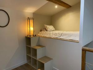 a small bedroom with a bed and shelves at La Romance de Grignan in Grignan