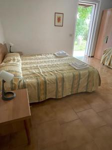a large bed in a room with a table at Agriturismo La Lupa in Madonna della Provvidenza