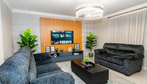 a living room with two couches and a chandelier at Ocean Blue Apartments in Cairo