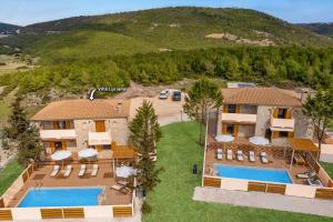 an aerial view of a villa with two swimming pools at Villa Luciana by Villa Plus in Koiliomenos