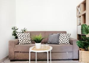 un soggiorno con divano, cuscini e tavolo di HoliHome_Colombo - Open Space, 100m dal mare! a Tortoreto