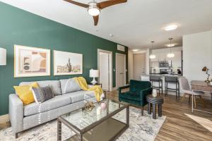 a living room with a couch and a table at Landing at Market Square Tower - 2 Bedrooms in Downtown Houston in Houston