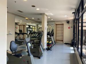 a gym with several treadmills and machines in a room at Suite dupla ao lado do aeroporto de Congonhas in Sao Paulo