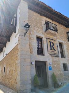 a building with a bird on the side of it at Hotel BESTPRICE Santillana in Santillana del Mar