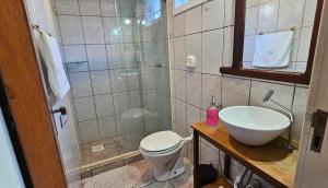 a bathroom with a shower and a toilet and a sink at Residencial Jade in Florianópolis