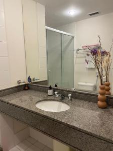 a bathroom counter with a sink and a mirror at Suite dupla ao lado do aeroporto de Congonhas in Sao Paulo
