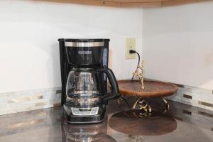 a coffee maker sitting on top of a table at Northern Lights Getaway Minutes to Ft Wainwright in North Pole