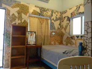 a bedroom with a bed and a wall with stars at Casa Vista Al Mar - Iguana Room in Puerto Escondido