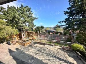 a backyard with a fence and a garden at Riverwood Home in Mississauga