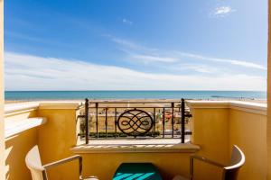 a balcony with a view of the beach at Hotel Metropole in Rimini